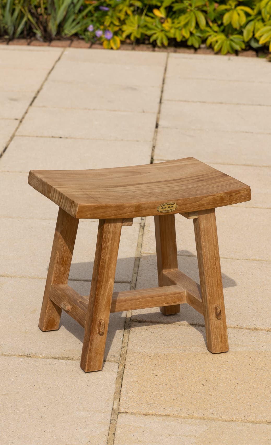 Rectangular teak stool on patio