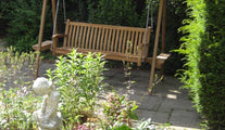 Teak Swing Seat with Ecru Canopy in the garden
