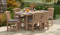 Fixed Teak Oval Garden Dining Table & 6 Winchester Dining Chairs Front Angled View Fully Dressed With Light Grey Cushions