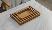 A Set of 3 Rectangular Teak Trays with Slotted Handle