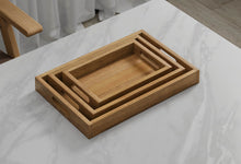 A Set of 3 Rectangular Teak Trays with Slotted Handle