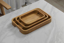 A Set of 3 Rectangular Teak Trays with Curved Corners and Integral Handle