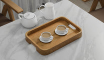 A Rectangular Teak Tray with Curved Corners and Integral Handle serving two cups of tea