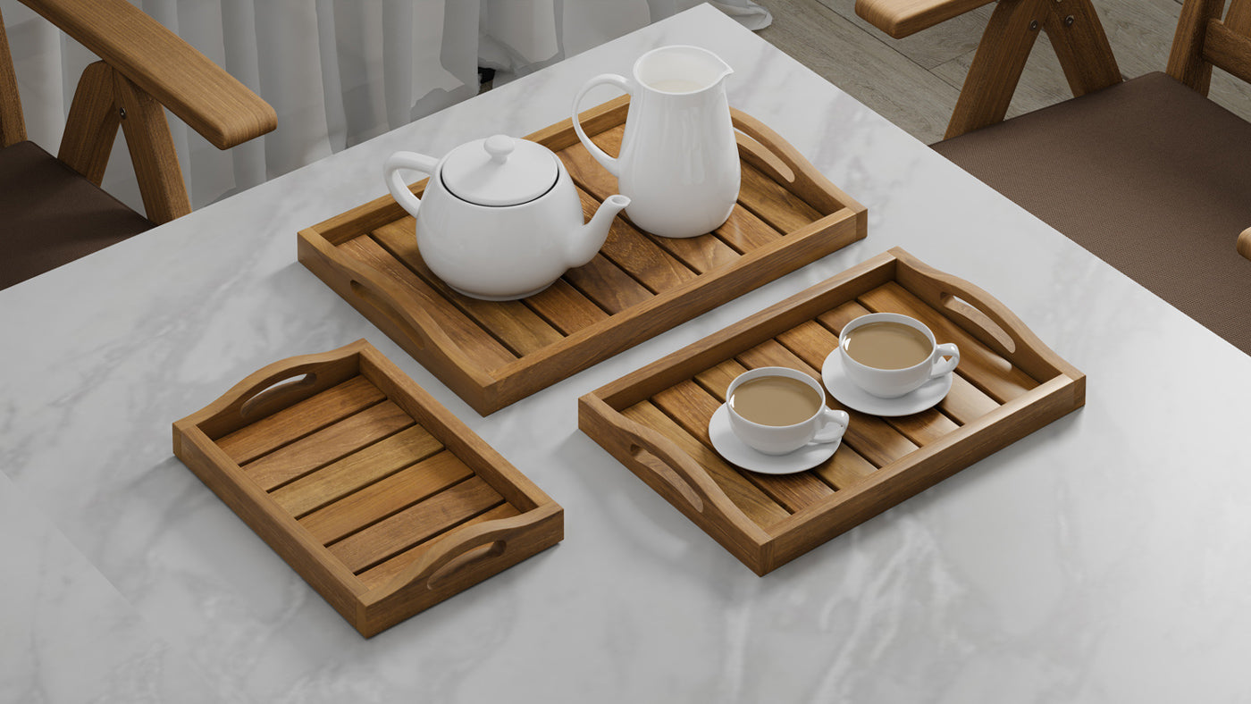 A Set of 3 Teak Trays with Arched Handle serving tea.